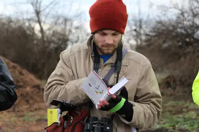 Photo of birder with field guide